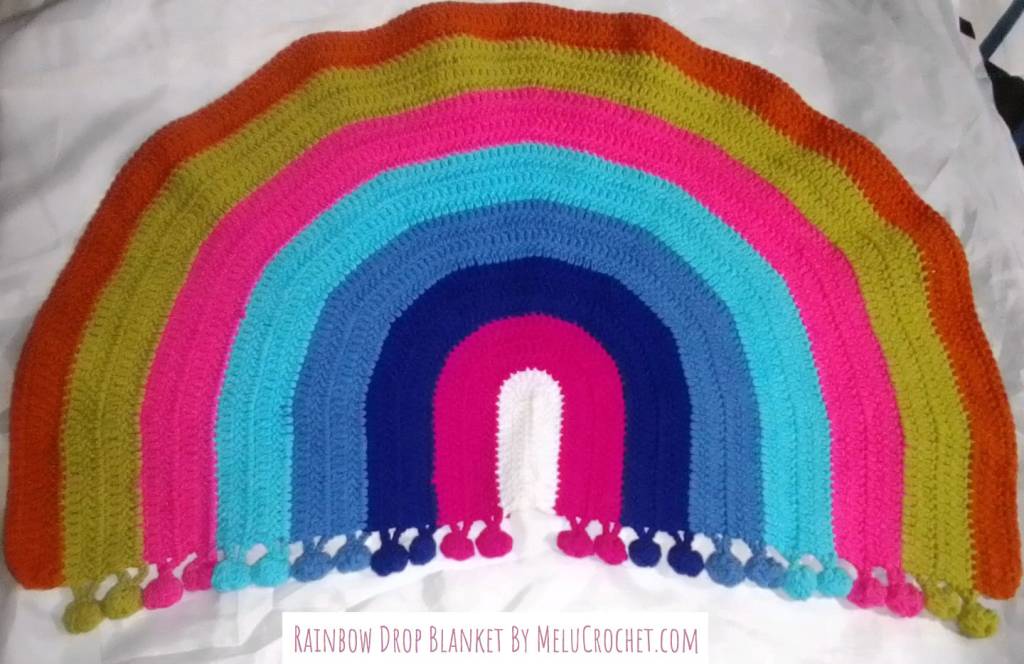 Rainbow shaped blanket with bobble pom pom fringe