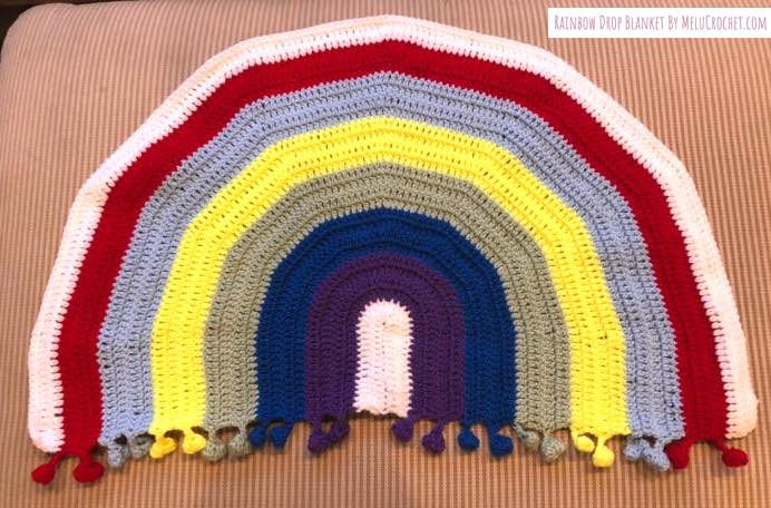Rainbow shaped blanket with bobble pom pom fringe- traditional colours