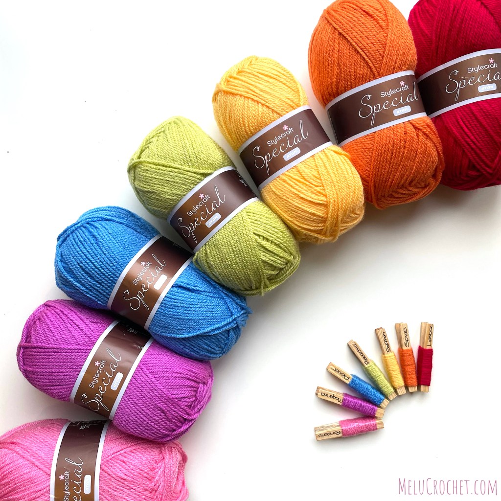 Stylecraft yarn in rainbow colours- red, orange, yellow, green, blue, purple, pink and corresponding yarn pegs.